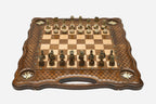 Carved chess board with four brass star inlays, lattice borders and ornate bronze-and-cream figural pieces set up for play
