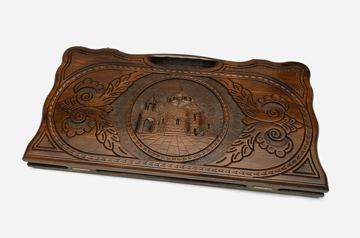 The backgammon board opened to show the wooden playing surface