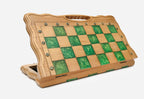 Angled view of the green epoxy folding chess set with its gold and dark bronze warrior pieces