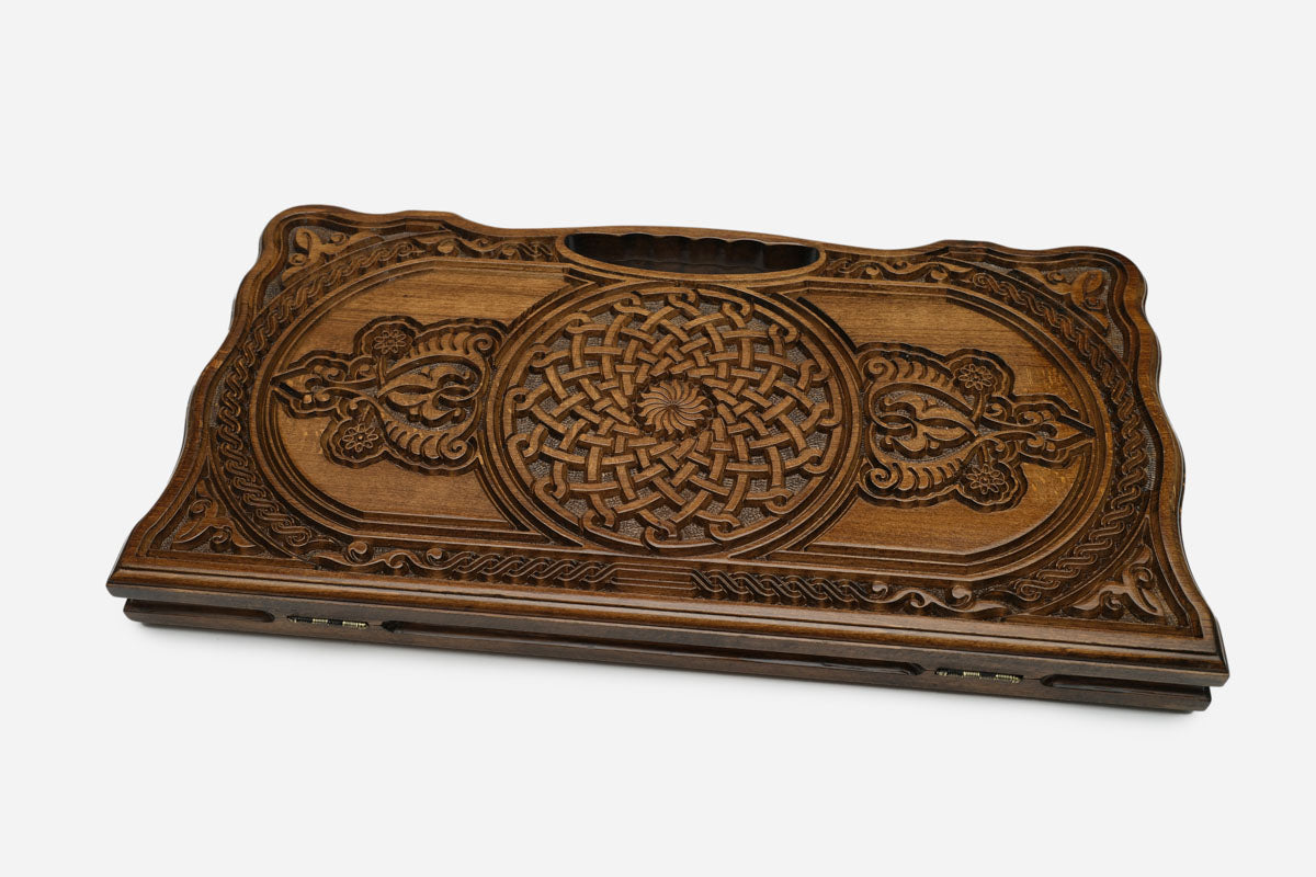 The backgammon board opened to show the wooden playing surface