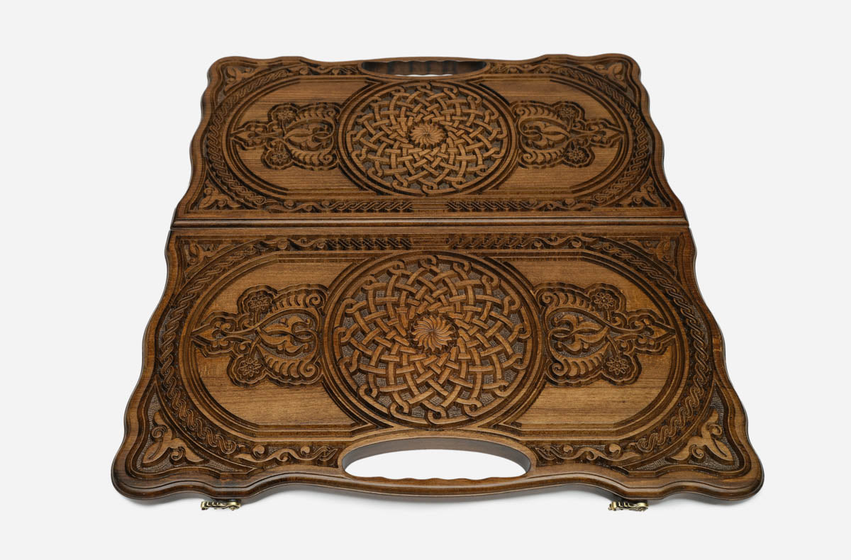 Angled view of the twin rosette carved backgammon board