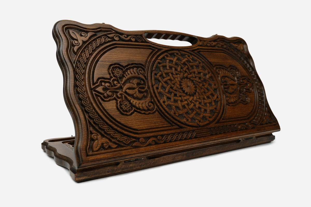 Carved beechwood backgammon board with twin floral and knotwork rosette medallions, with a carry handle, propped open