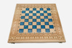 Close-up of the beech and walnut chess pieces on the blue epoxy squares