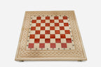 Close-up of the beech and walnut chess pieces on the red epoxy squares