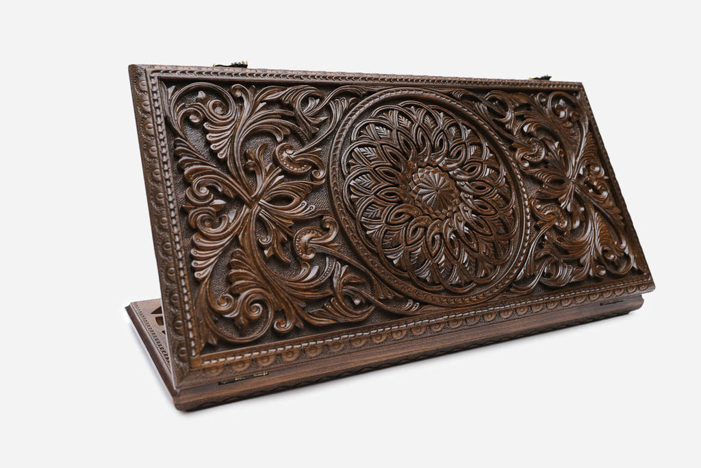 The folded board shown closed, revealing a deep-relief carved rosette medallion and acanthus scrollwork