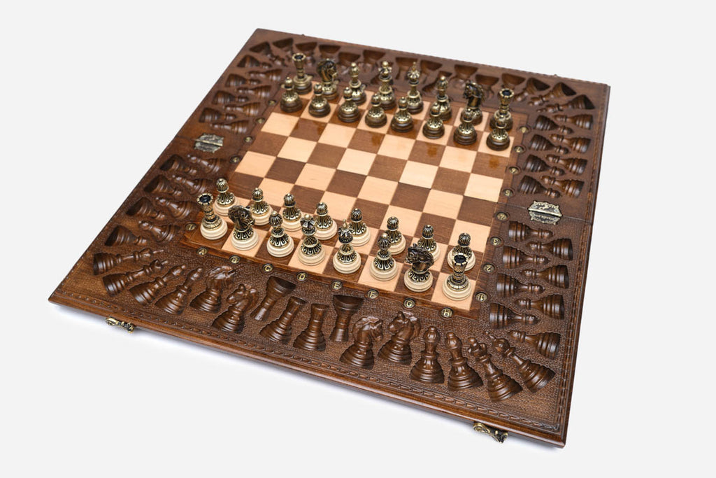 Detail of the carved border and bronze coordinate markers around the board