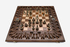 Close-up of the ornate bronze chess pieces with sculpted crowns and cream bases
