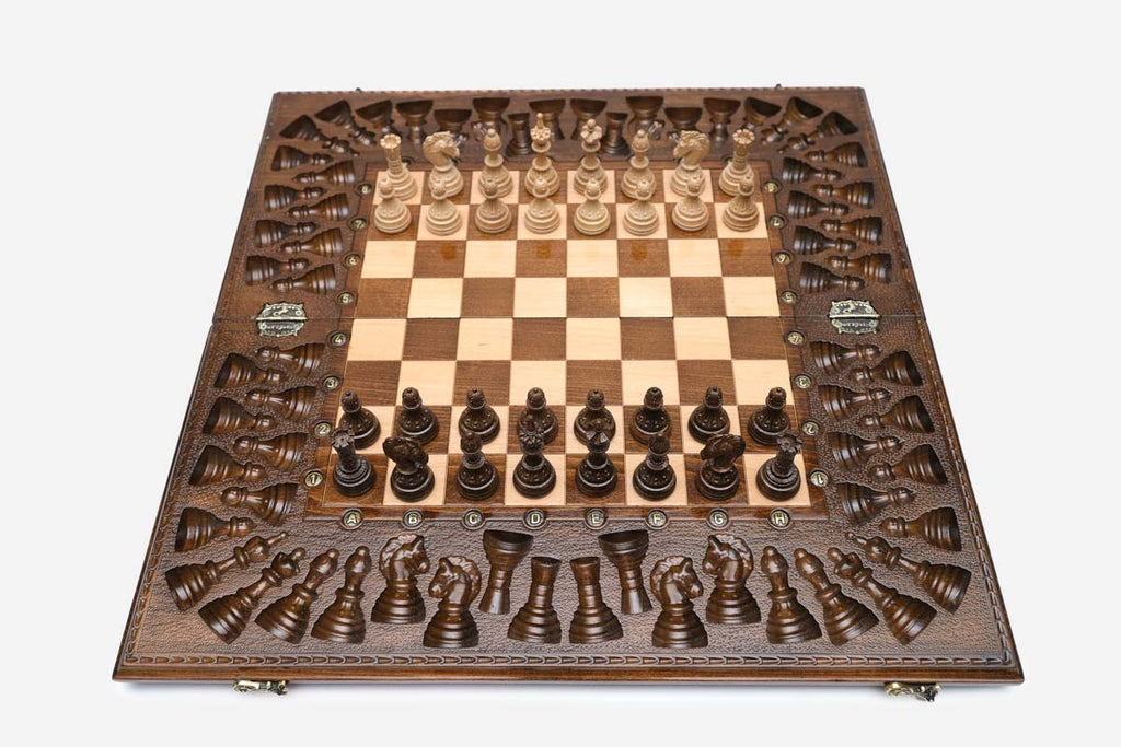Angled view of the grand carved chess set with its bronze figural pieces