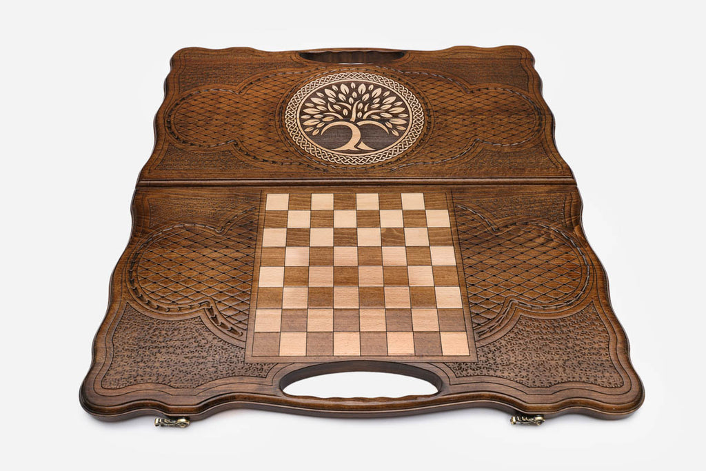 Angled view of the tree of life medallion carved backgammon board