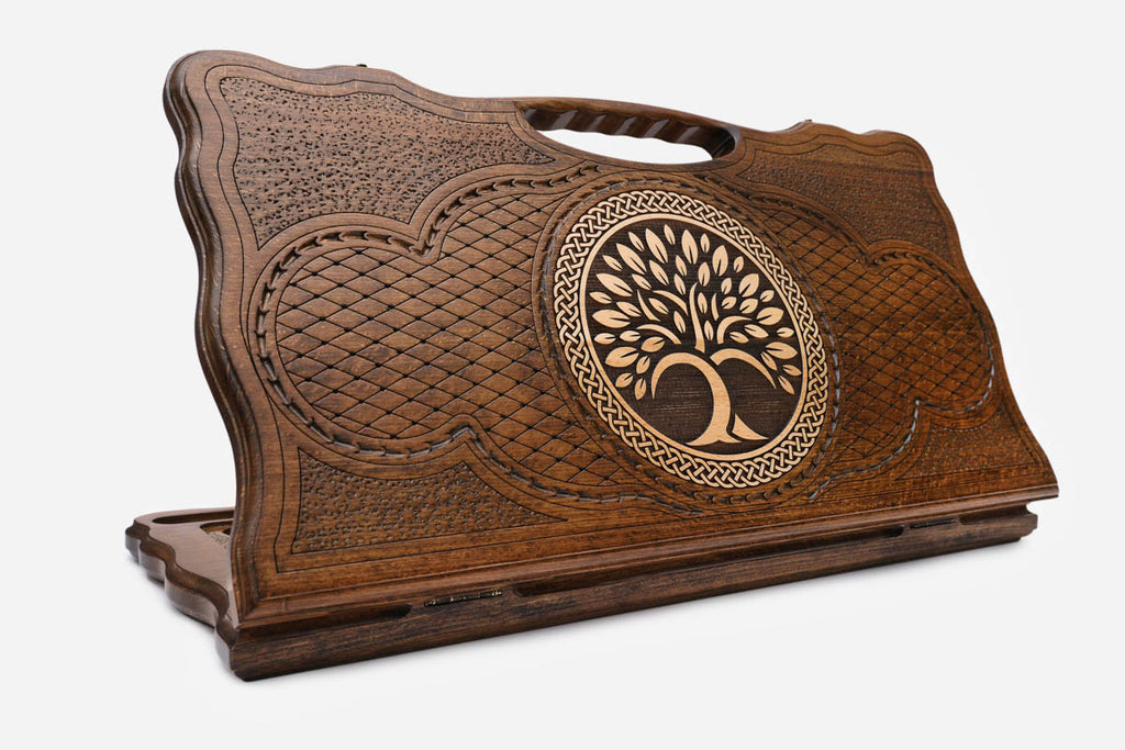 Carved beechwood backgammon board with a tree of life in a circular medallion, with a carry handle, propped open