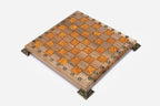 Close-up of the figural bronze warrior and column pieces on the orange epoxy squares