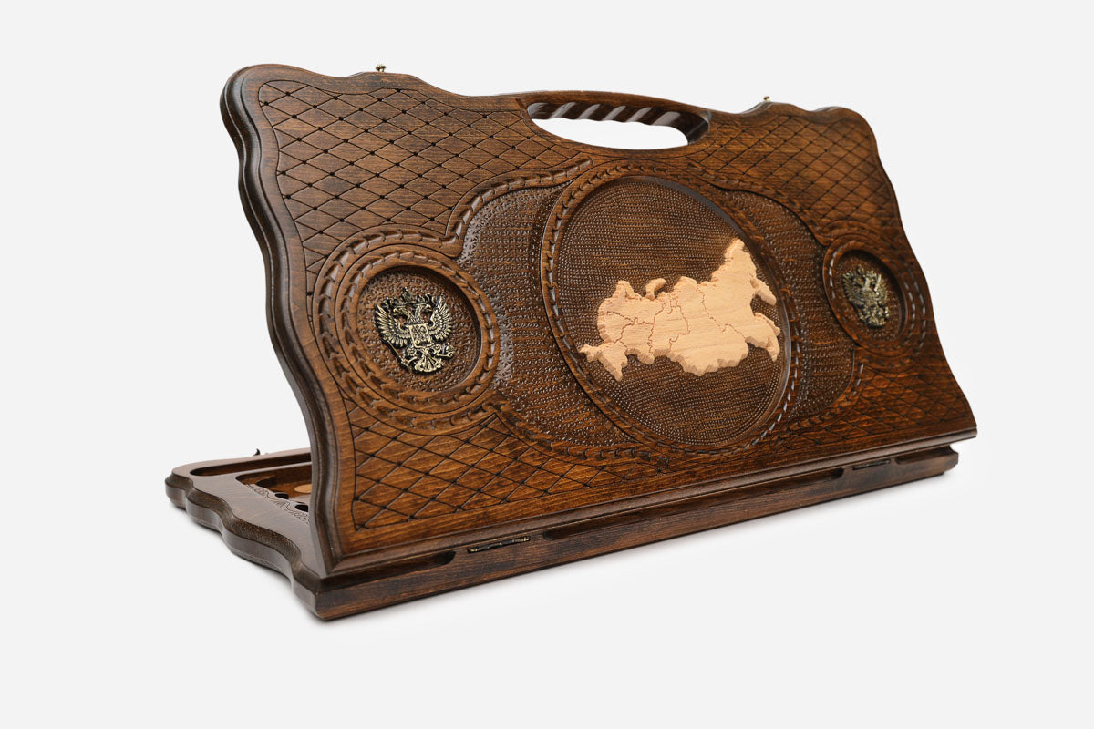 Carved beechwood backgammon board with the map of Russia and bronze eagle medallions, with a carry handle, propped open