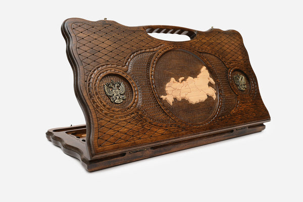 Carved beechwood backgammon board with the map of Russia and bronze eagle medallions, with a carry handle, propped open