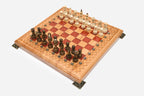 Angled view of the red epoxy chess set with its wooden pieces