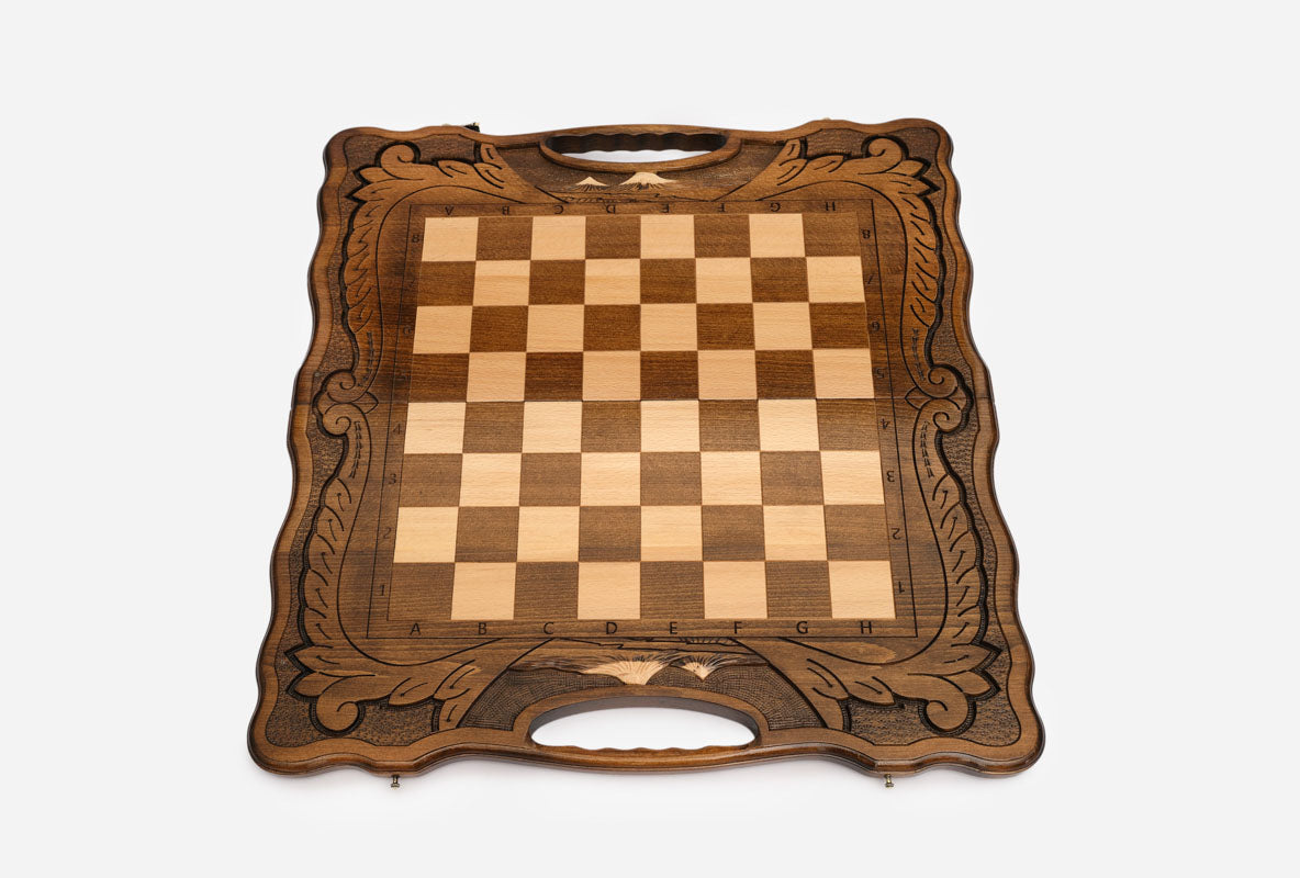Overhead view of the full set of light and dark wooden pieces in starting position