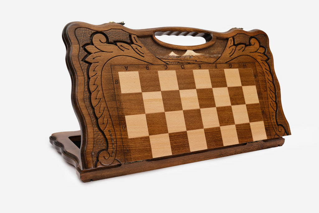 Top-down view of the opened board showing the chessboard and carved borders