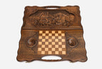 Angled view of the hunter and bear carved backgammon board