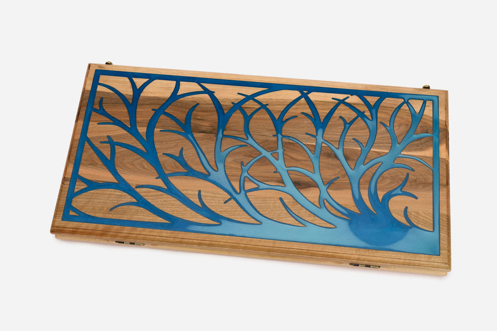 Close-up of the blue epoxy tree branches on the walnut surface