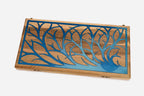 Close-up of the blue epoxy tree branches on the walnut surface