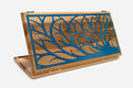 Folding walnut backgammon board carved with a tree of life filled with blue epoxy, propped open