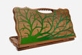 Folding walnut backgammon board with a green epoxy tree of life design and a cut-out carry handle, standing upright