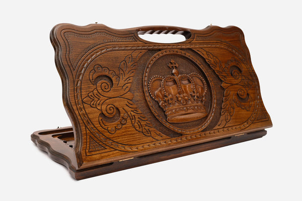 Carved beechwood backgammon board with a royal crown medallion and a carry handle, propped open
