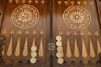 Close-up of the backgammon checkers, dice and cup on the Handle Eagle table