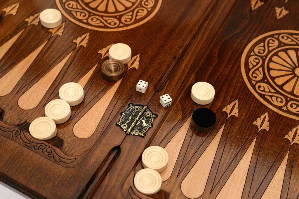 Close-up of the backgammon checkers, dice and cup on the Handle Lion table