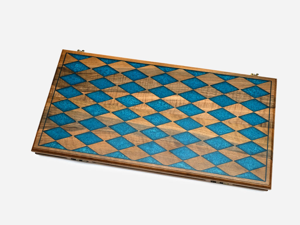 Folding walnut backgammon board with a blue epoxy diamond harlequin pattern on the closed exterior