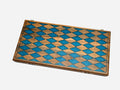 Folding walnut backgammon board with a blue epoxy diamond harlequin pattern on the closed exterior