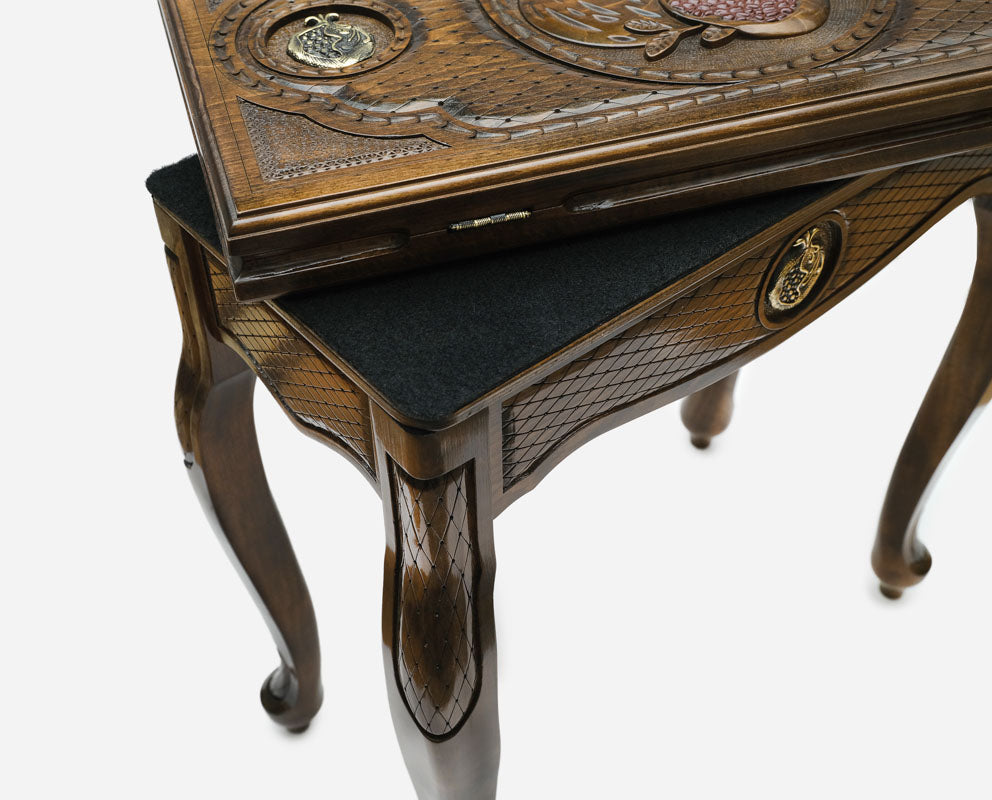 Close-up of the bronze pomegranate medallion on the Handle backgammon table lid
