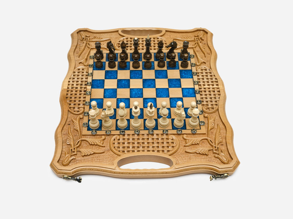 Light beechwood folding chess board with royal-blue epoxy squares and wooden Staunton pieces set up for play