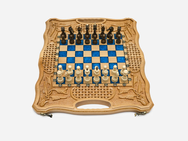 Light beechwood folding chess board with royal-blue epoxy squares and wooden Staunton pieces set up for play