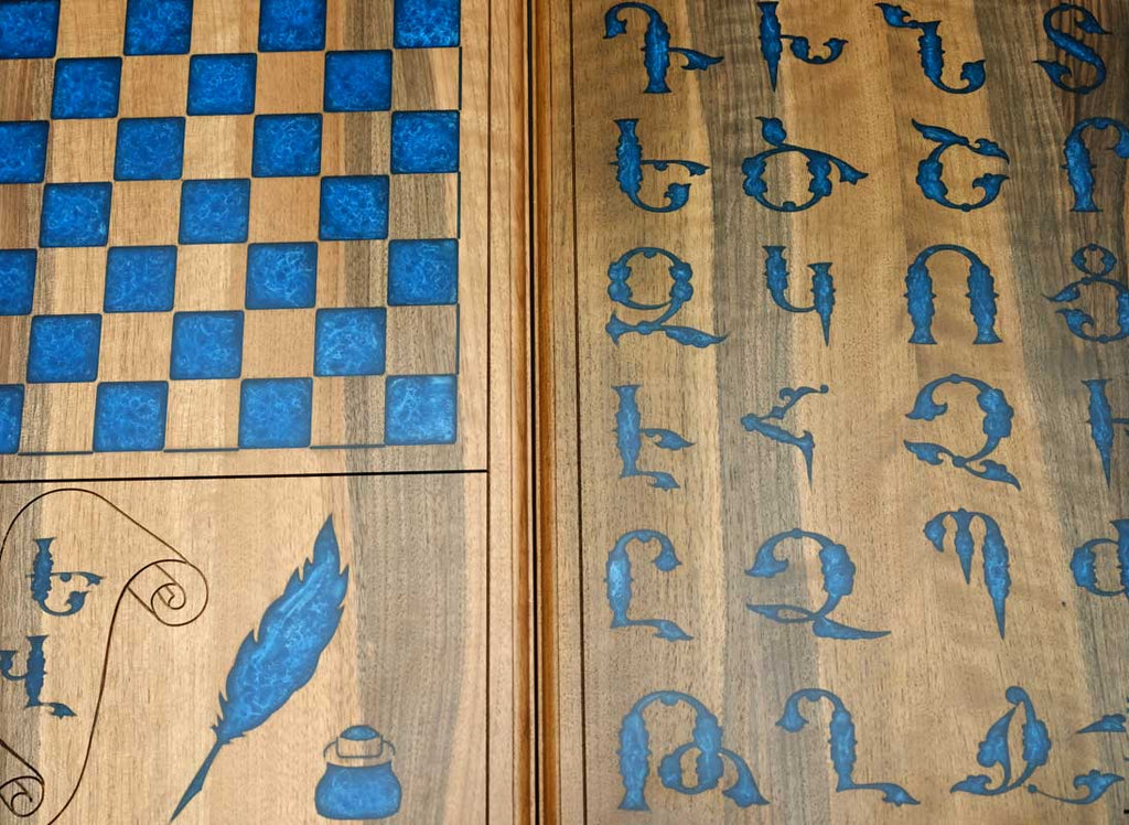 Close-up of the blue epoxy Armenian letters on the walnut surface