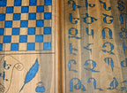 Close-up of the blue epoxy Armenian letters on the walnut surface