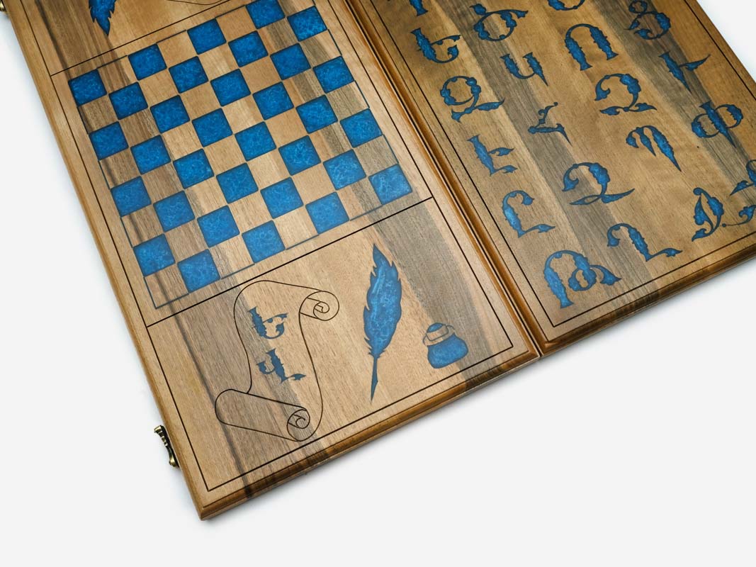 The backgammon board opened to show the playing points and carved rosettes