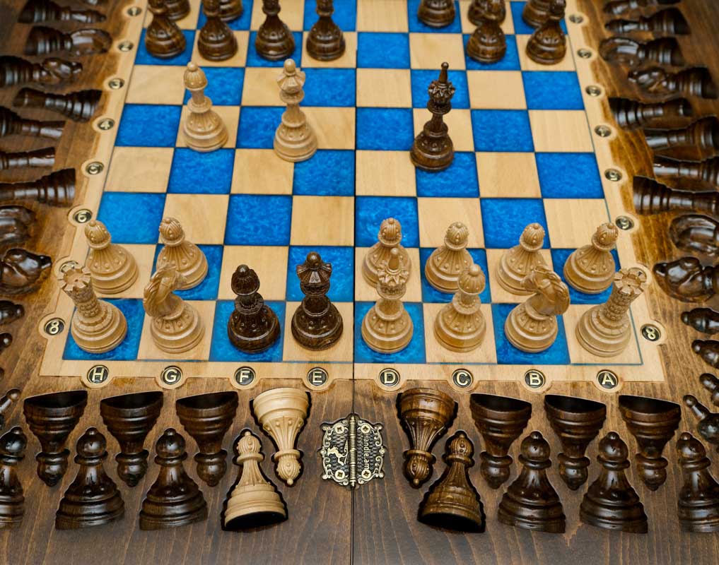 Overhead view of the blue epoxy chess board and its wooden pieces