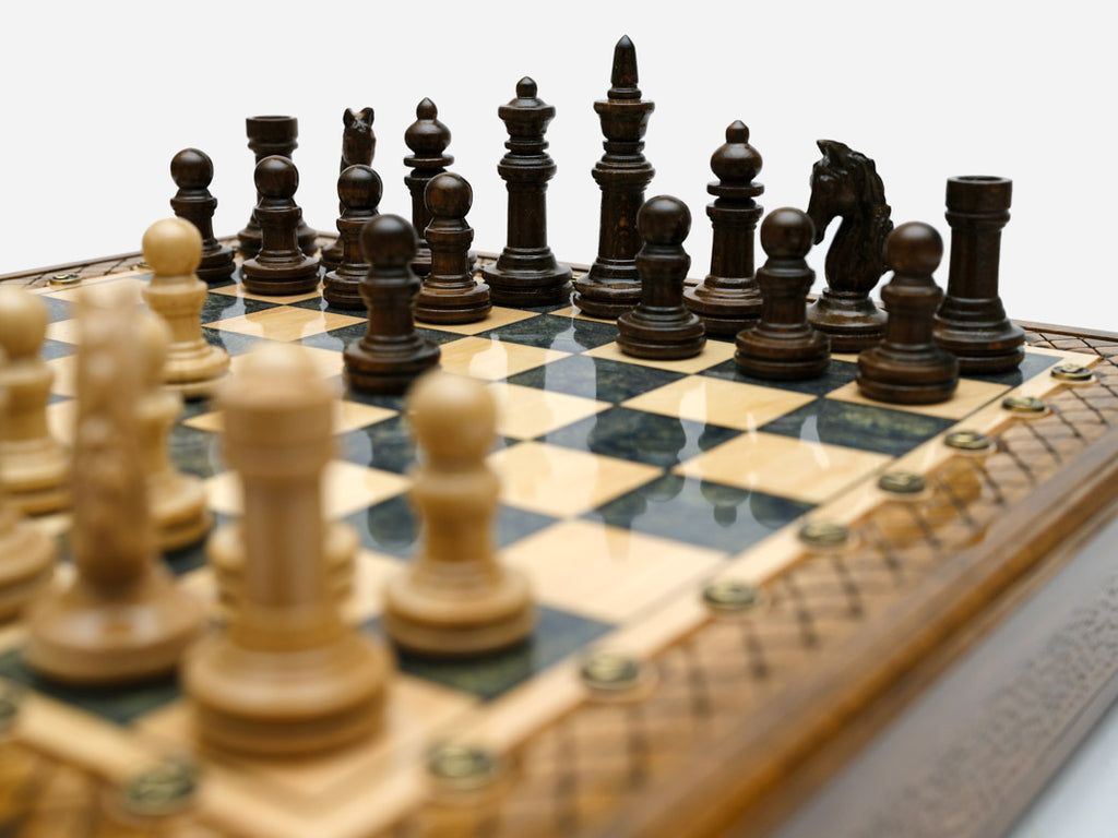 Close-up of the wood chess pieces on the Handle Gray Epoxy board
