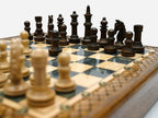 Close-up of the wood chess pieces on the Handle Gray Epoxy board