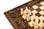 Carved medallion detail on the chess-backgammon table