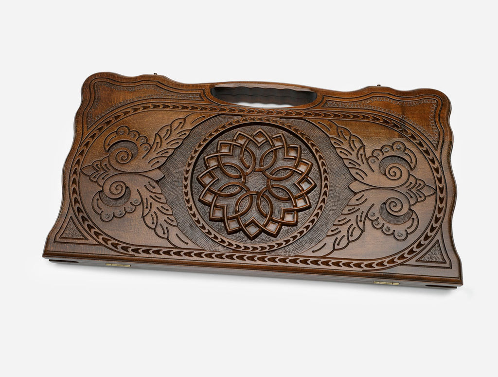 Angled view of the floral rosette carved backgammon board
