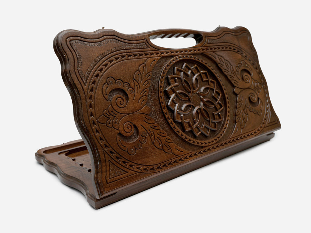Carved beechwood backgammon board with a floral rosette medallion and a carry handle, propped open