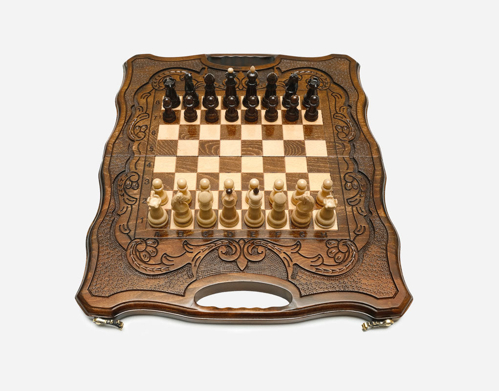 Top-down view of the opened board with floral-carved borders, backgammon points and the full set of pieces