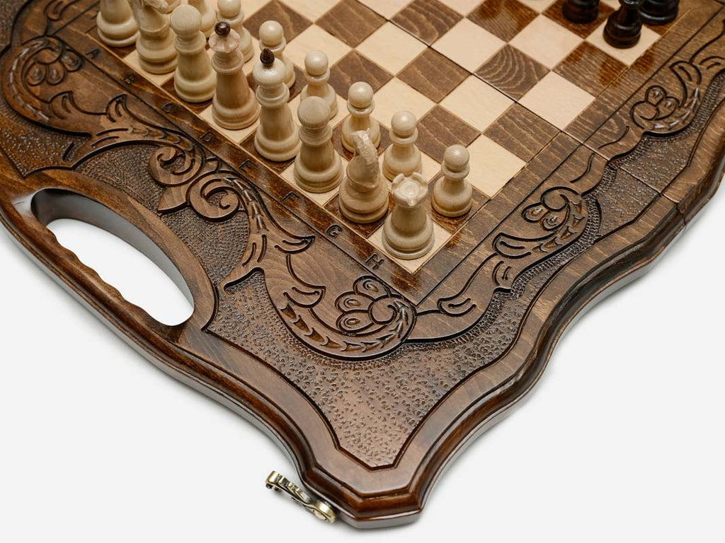 The folding chess board partly closed, showing its briefcase form and carved handle