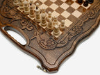 The folding chess board partly closed, showing its briefcase form and carved handle