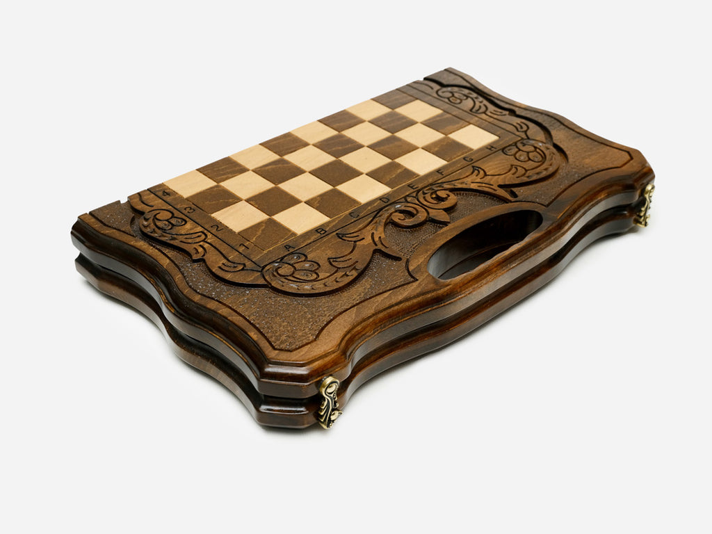 Overhead view of the dark walnut chessboard with light and dark wooden pieces in starting position