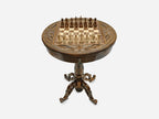 Hand-carved round wooden chess table with a full chess set arranged on the board