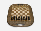 The folding chess-backgammon board standing with its rounded top and carry handle