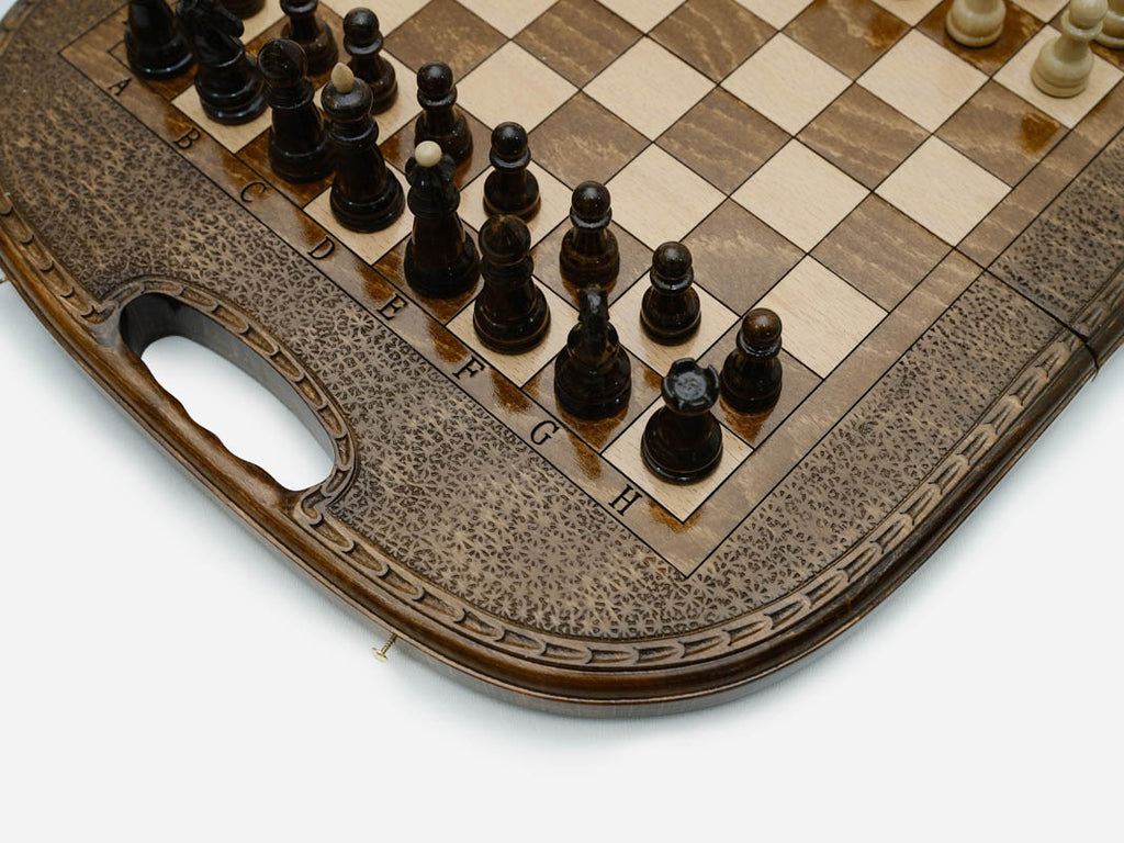 Overhead view of the chessboard with the full set of light and dark pieces
