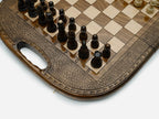 Overhead view of the chessboard with the full set of light and dark pieces